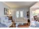 Inviting living room boasts hardwood floors, elegant furniture, and access to outdoor space at 1159 Belfair Way, Chapel Hill, NC 27517