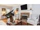 Living room with a fireplace, grand piano, hardwood floors, and a neutral color palette at 1159 Belfair Way, Chapel Hill, NC 27517
