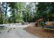 Community playground with swings, slides, and picnic benches at 1159 Belfair Way, Chapel Hill, NC 27517
