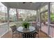 Covered porch with a round table, chairs, and view of the backyard at 1159 Belfair Way, Chapel Hill, NC 27517