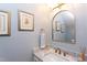 Elegant powder room features a marble countertop, gold fixtures, and stylish decor at 1159 Belfair Way, Chapel Hill, NC 27517