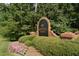 Downing Creek community sign surrounded by flowers and shrubs at 1159 Belfair Way, Chapel Hill, NC 27517