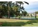 Community tennis court surrounded by tall trees at 1159 Belfair Way, Chapel Hill, NC 27517