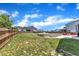 Spacious, partially fenced backyard features a stone patio and ample green space at 1160 Duke Farm Dr, Wake Forest, NC 27587
