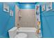 Bright bathroom features a tub with a tiled shower and dinosaur-themed decor at 1160 Duke Farm Dr, Wake Forest, NC 27587
