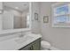 Stylish bathroom with olive green vanity, white quartz countertop, and a large mirror reflecting the well-lit space at 1160 Duke Farm Dr, Wake Forest, NC 27587