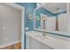 Stylish bathroom with a quartz countertop vanity, bright blue walls, and decorative accents at 1160 Duke Farm Dr, Wake Forest, NC 27587