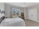 Neutral bedroom with a large window and white comforter featuring a bookcase and closet at 1160 Duke Farm Dr, Wake Forest, NC 27587