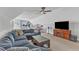 Comfortable den with a large sectional sofa and a television set on a wooden stand at 1160 Duke Farm Dr, Wake Forest, NC 27587