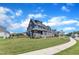 Stately home boasts manicured lawn, stone accents, and charming front porch at 1160 Duke Farm Dr, Wake Forest, NC 27587