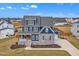 Beautiful two-story home with a covered front porch, stone accents, and a manicured lawn at 1160 Duke Farm Dr, Wake Forest, NC 27587