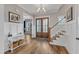 Bright foyer with wood floors, staircase, and paneled walls creates a welcoming entrance to the home at 1160 Duke Farm Dr, Wake Forest, NC 27587