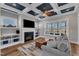 Cozy living room featuring a fireplace, built-in shelves, coffered ceiling, and a comfortable seating area at 1160 Duke Farm Dr, Wake Forest, NC 27587