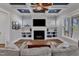Comfortable living room showcasing a fireplace, built-in shelves, coffered ceiling, and a plush sofa at 1160 Duke Farm Dr, Wake Forest, NC 27587
