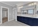 Main bathroom featuring a double vanity, large mirror, and linen closet access at 1160 Duke Farm Dr, Wake Forest, NC 27587
