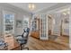 Home office featuring wood floors, natural light, and a stylish cabinet for books and display items at 1160 Duke Farm Dr, Wake Forest, NC 27587