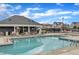 Community pool with lounge seating, a shallow area, and a nearby clubhouse at 1160 Duke Farm Dr, Wake Forest, NC 27587