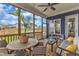 Relaxing screened-in porch featuring an outdoor dining area and backyard scenery at 1160 Duke Farm Dr, Wake Forest, NC 27587