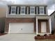 Charming two-story home with a brick facade, attached garage, and inviting front entrance at 1165 Solace Way, Rolesville, NC 27571