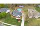 Backyard aerial featuring landscaping, mature trees, a well-maintained lawn, and proximity to the outbuilding at 124 Holly Ridge Ln, Mebane, NC 27302