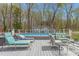 Backyard with an above-ground pool surrounded by a wooden deck, lounge chairs, and a privacy fence at 124 Holly Ridge Ln, Mebane, NC 27302