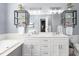 Bathroom features a dual sink vanity, framed mirrors, modern sconces, a soaking tub, and decorative shelving at 124 Holly Ridge Ln, Mebane, NC 27302