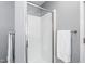 Bathroom featuring a glass-enclosed shower, neutral color palette, and a towel rack with fresh white towels at 124 Holly Ridge Ln, Mebane, NC 27302