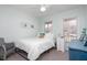 Bedroom featuring a ceiling fan, two windows, neutral color palette, and matching nightstand and desk at 124 Holly Ridge Ln, Mebane, NC 27302