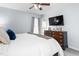 Bright bedroom featuring a ceiling fan, a wooden dresser with a TV, and neutral-toned walls and flooring at 124 Holly Ridge Ln, Mebane, NC 27302