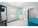 Well-lit exercise room with fitness equipment, a patterned rug, and a charming white cabinet at 124 Holly Ridge Ln, Mebane, NC 27302