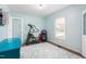 Well-lit exercise room with fitness equipment, a patterned rug, and a light blue accent wall at 124 Holly Ridge Ln, Mebane, NC 27302