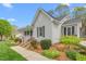 Charming single story home with attractive landscaping, walkway, and architectural detail at 124 Holly Ridge Ln, Mebane, NC 27302