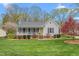 Charming single story home with a well-maintained lawn, inviting porch, and attractive landscaping at 124 Holly Ridge Ln, Mebane, NC 27302