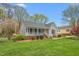 Charming single story home with a well-maintained lawn, inviting porch, and attractive landscaping at 124 Holly Ridge Ln, Mebane, NC 27302