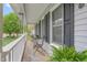 Relaxing front porch featuring a table and chairs, and a view of the landscaped front yard at 124 Holly Ridge Ln, Mebane, NC 27302