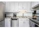 Bright kitchen with stainless steel appliances, granite countertops, neutral paint, white cabinets, and lots of light at 124 Holly Ridge Ln, Mebane, NC 27302