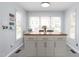 Neutral kitchen with a kitchen island and wood countertop, tile floors, lots of windows and natural light at 124 Holly Ridge Ln, Mebane, NC 27302