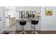 Kitchen seating at the breakfast bar features stainless steel appliances, granite countertops, and white cabinets at 124 Holly Ridge Ln, Mebane, NC 27302