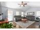 Cozy living room featuring neutral paint, hardwood floors, two gray couches, and plenty of natural light at 124 Holly Ridge Ln, Mebane, NC 27302