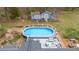Aerial view of backyard pool and deck area with outdoor seating, creating a relaxing outdoor oasis at 124 Holly Ridge Ln, Mebane, NC 27302