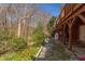 The backyard features a mix of trees, vegetation, and a gravel pathway, offering a serene outdoor setting at 125 Long Shadow Pl, Durham, NC 27713