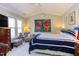 Bright bedroom featuring vaulted ceilings, a large bed, cozy seating, and ample natural light at 125 Long Shadow Pl, Durham, NC 27713