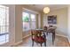 Sunlit dining area with a view of the outdoors and a unique modern light fixture at 125 Long Shadow Pl, Durham, NC 27713