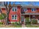 Charming townhouse with red siding, manicured landscaping, and inviting front porch at 125 Long Shadow Pl, Durham, NC 27713