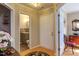 Hallway with hardwood floors and a door to a bathroom with a gray vanity at 125 Long Shadow Pl, Durham, NC 27713