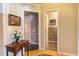 Hallway with hardwood floors, artwork, and views into the bathroom and another room at 125 Long Shadow Pl, Durham, NC 27713