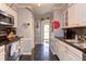 Bright kitchen with black granite countertops, stainless appliances, and unique painted wall decor at 125 Long Shadow Pl, Durham, NC 27713
