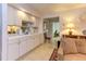 This kitchenette features white cabinetry, a sink, and tiled floors, providing a compact and functional space at 125 Long Shadow Pl, Durham, NC 27713