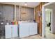A functional laundry room with a washer, dryer, and a storage cabinet against a block wall at 125 Long Shadow Pl, Durham, NC 27713
