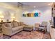 A comfortable living room with a sectional sofa, colorful artwork, and a decorative rug, perfect for relaxing at 125 Long Shadow Pl, Durham, NC 27713